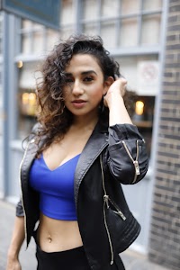 Woman in Street Fashion Pose Outside Urban Shopfront