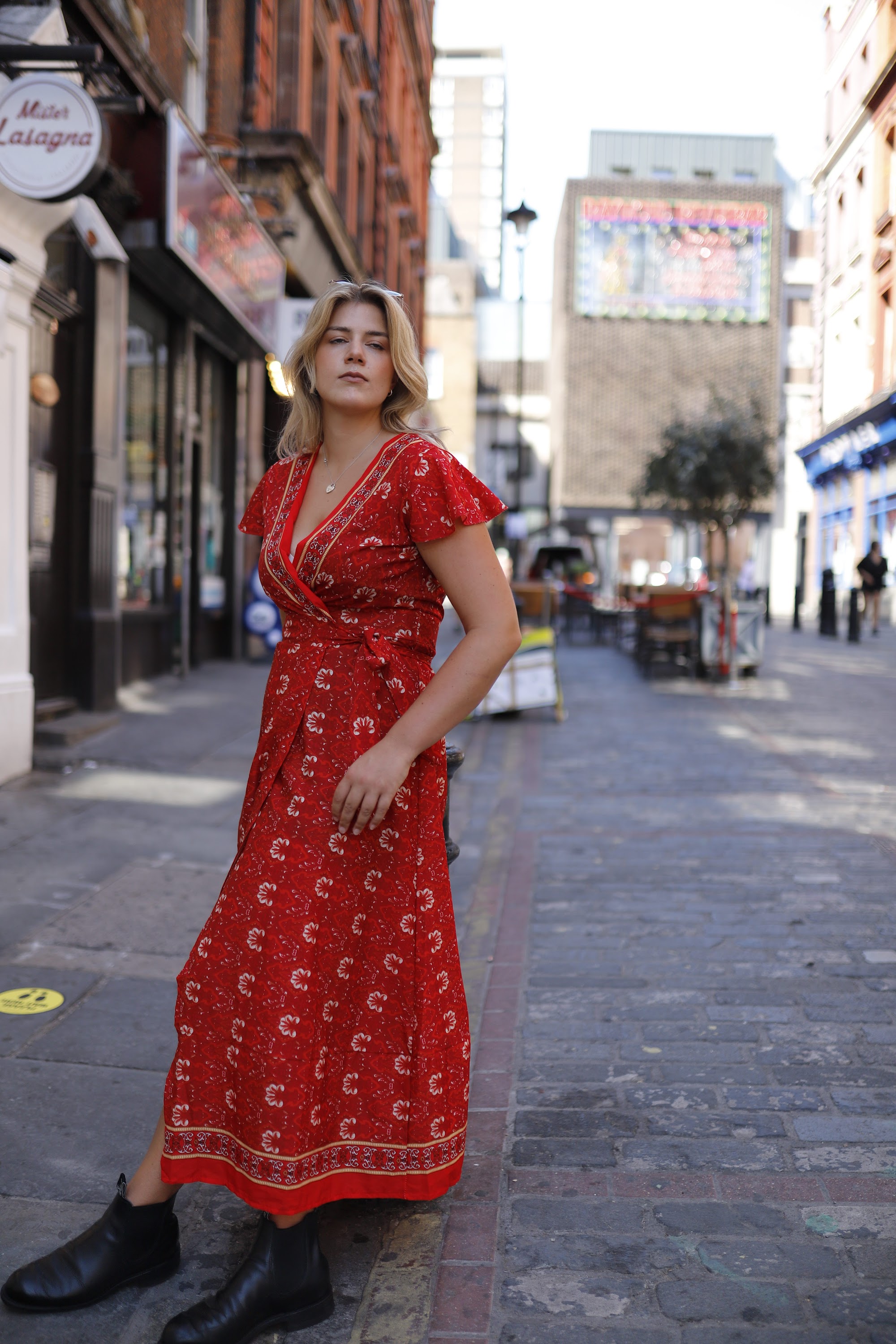 Young Woman in Floral Dress at Indoor Arcade Corridor