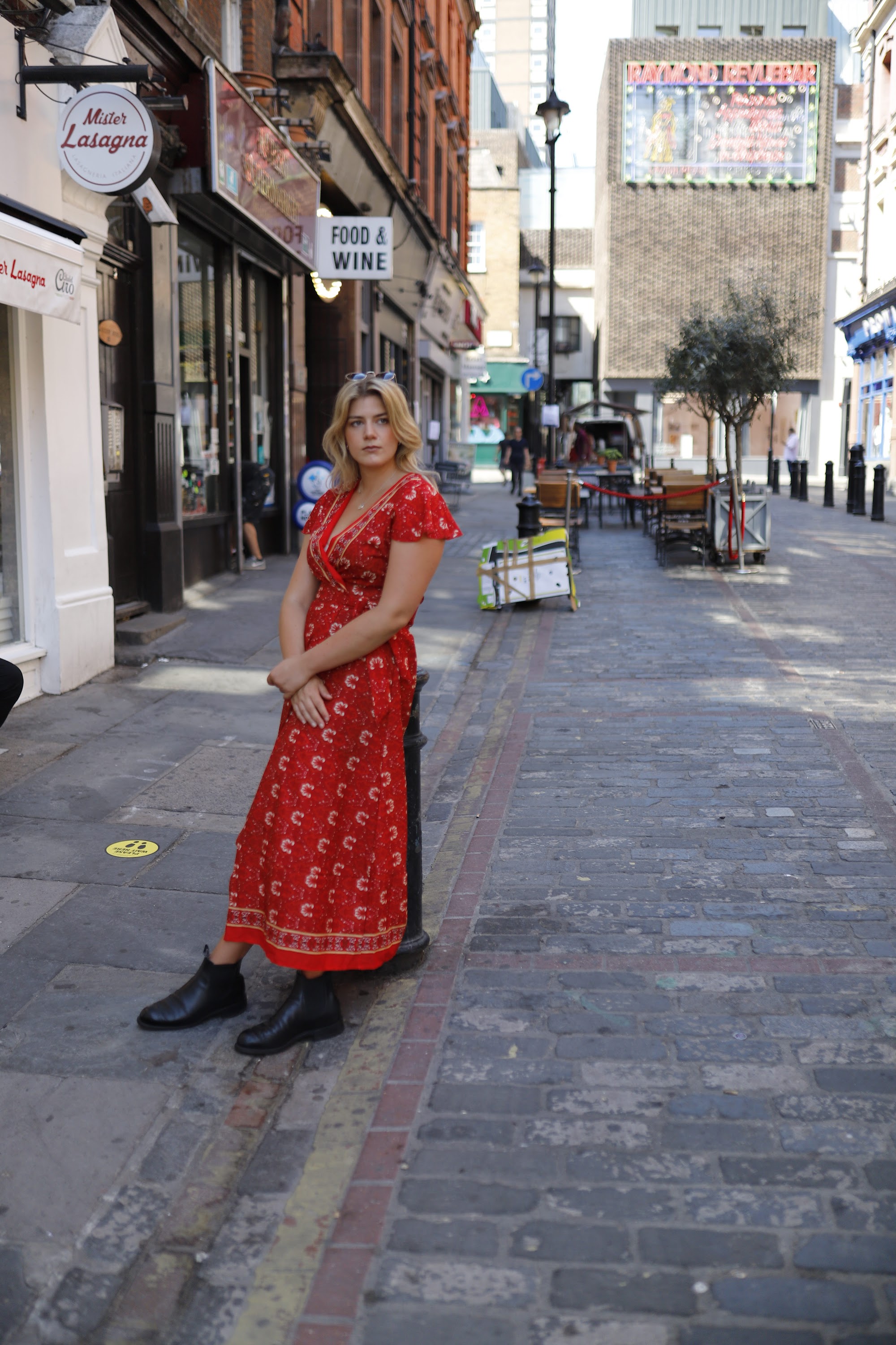 Young Woman in Floral Dress at Indoor Arcade Corridor