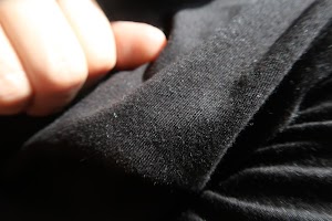 Close-up of Hand Holding Black Fabric