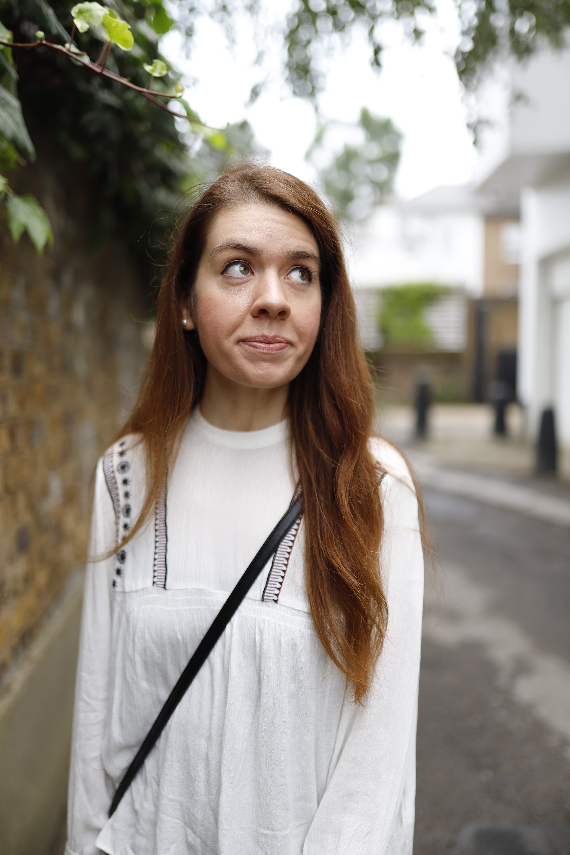 Young Woman Posing by Riverside Railing