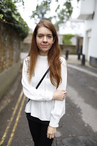 Young Woman Posing by Riverside Railing