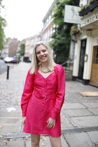 Young Woman in Pink Dress on Historic Pedestrian Lane