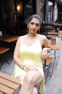 Woman in Yellow Fringe Dress on European City Street