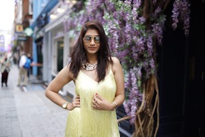 Woman in Yellow Fringe Dress on European City Street