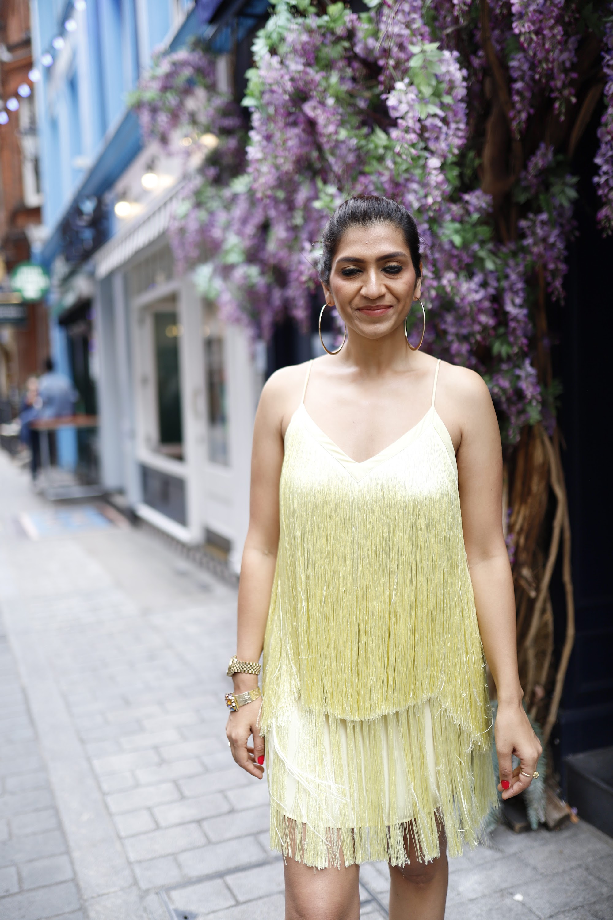 Woman in Yellow Fringe Dress on European City Street