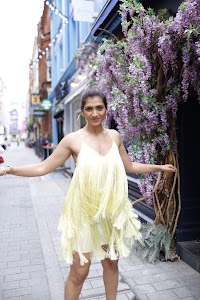 Woman in Yellow Fringe Dress on European City Street