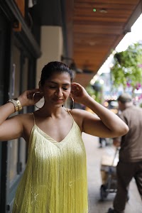 Woman in Yellow Fringe Dress on European City Street