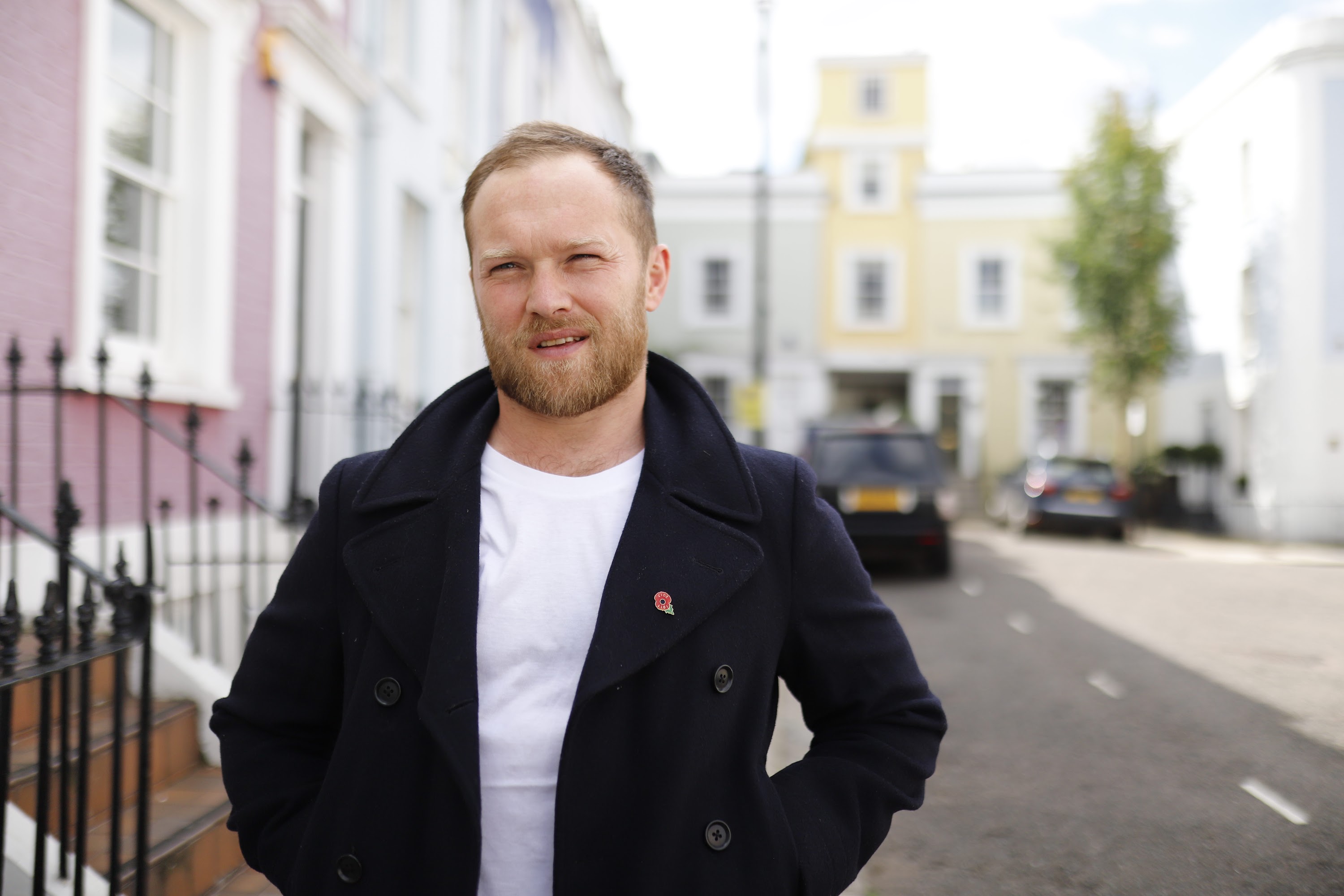 Man Leaning Against Brick Wall on London Street