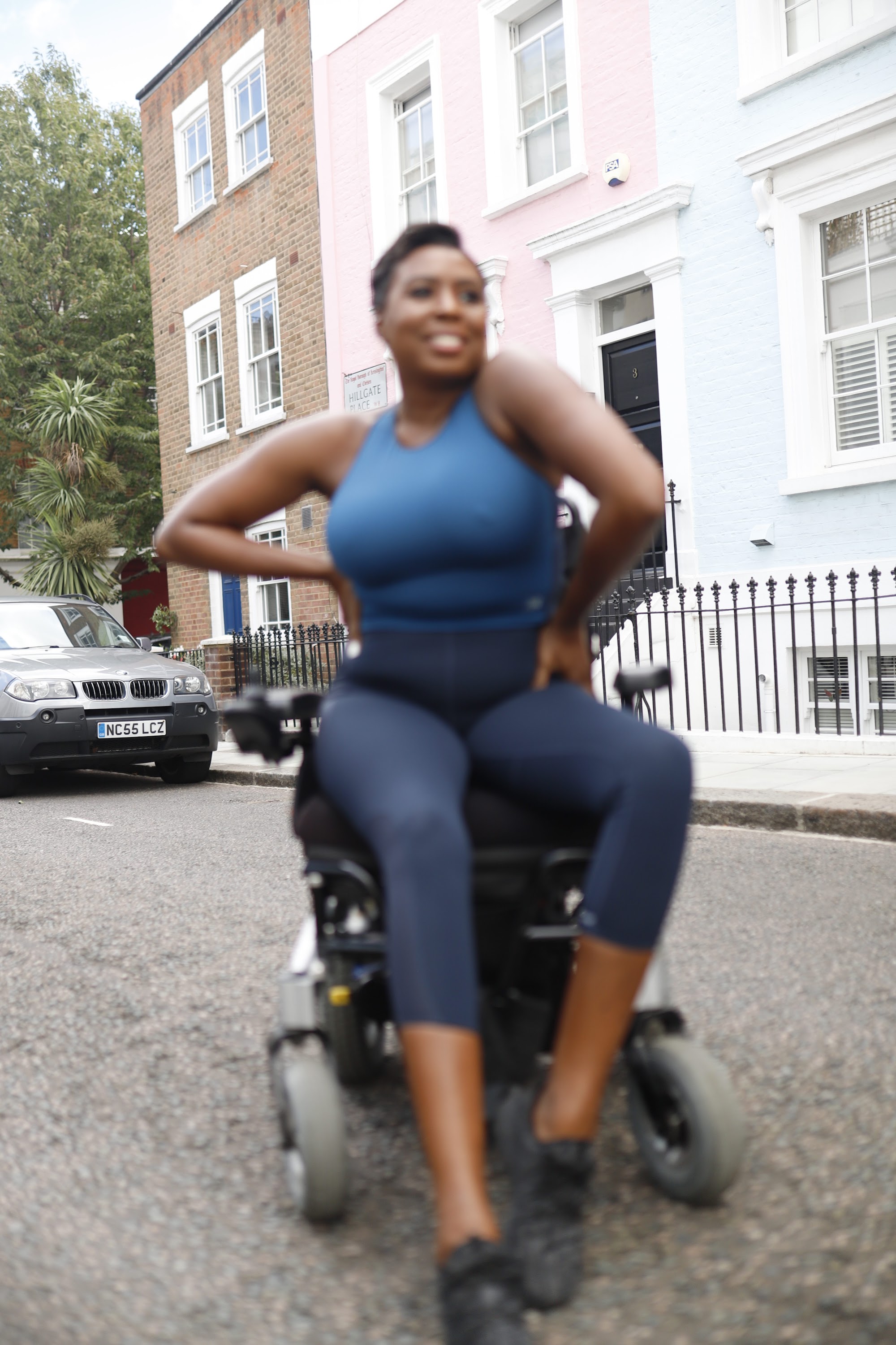 Woman in Power Wheelchair on London Residential Pavement
