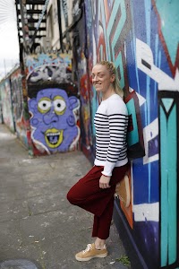 Blonde Woman in Burgundy Jumpsuit on Urban Street