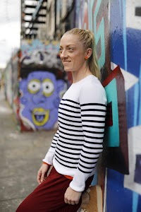 Blonde Woman in Burgundy Jumpsuit on Urban Street