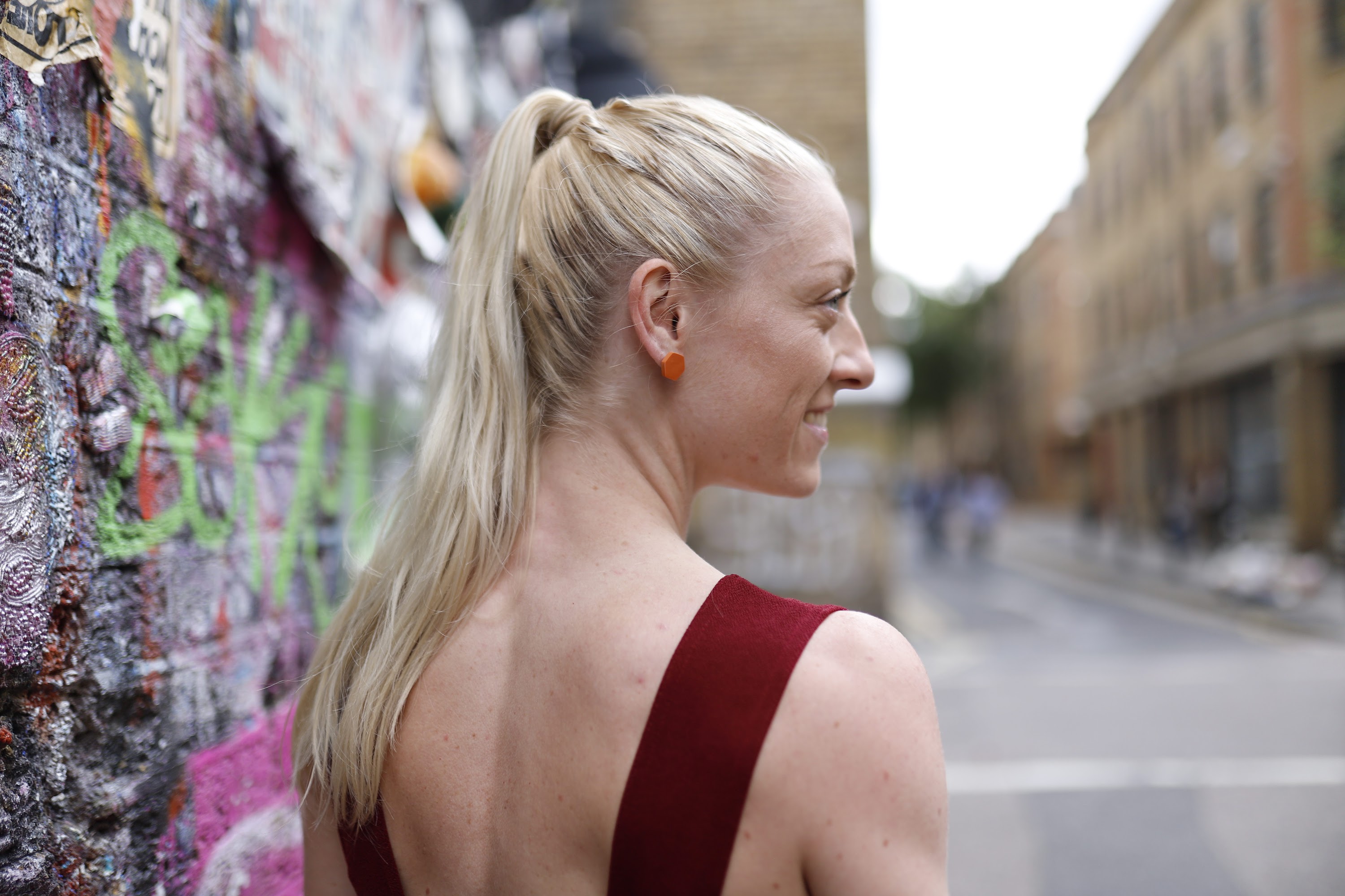 Blonde Woman in Burgundy Jumpsuit on Urban Street