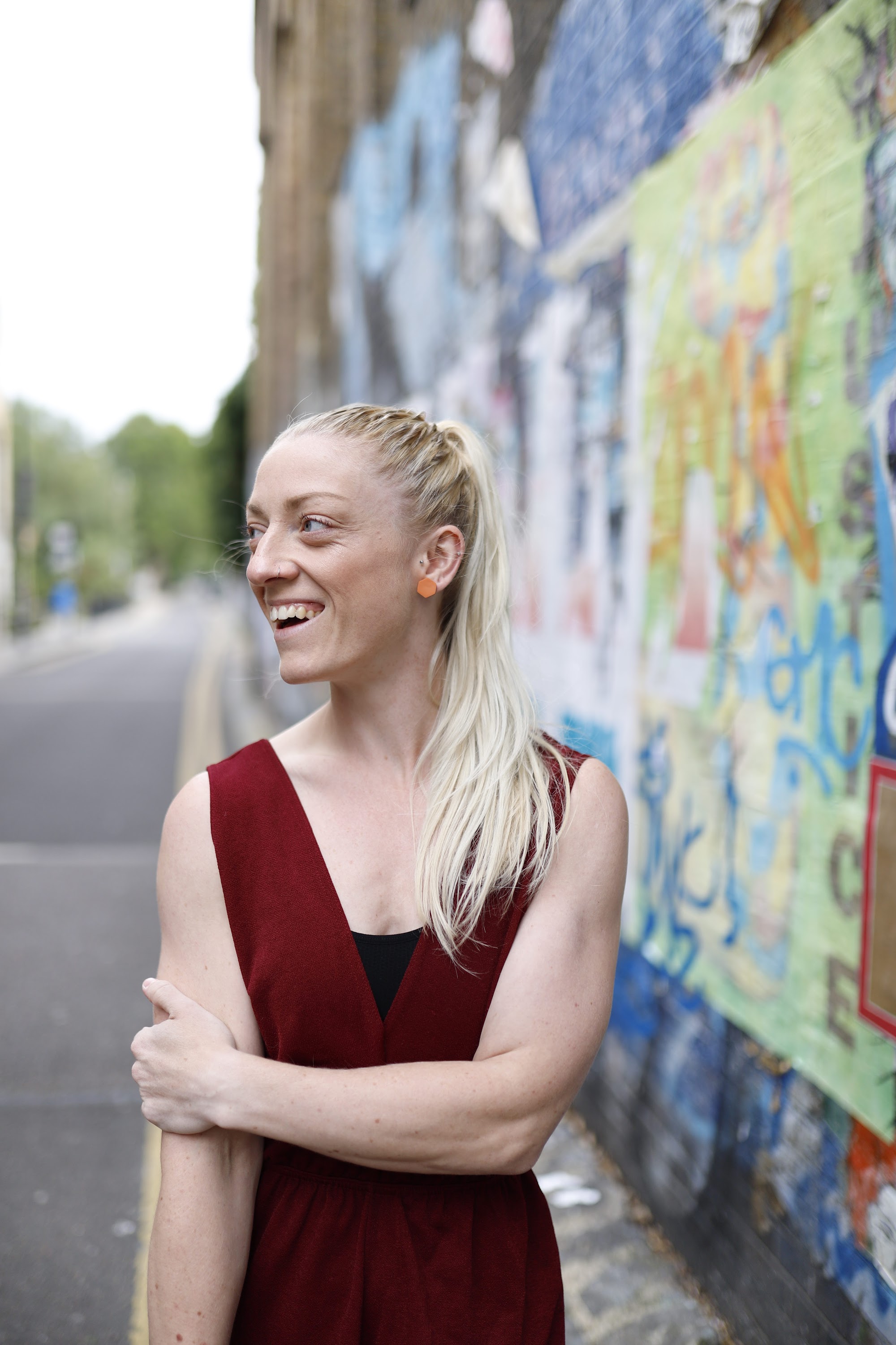 Blonde Woman in Burgundy Jumpsuit on Urban Street