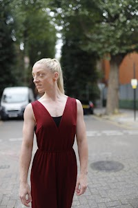Blonde Woman in Burgundy Jumpsuit on Urban Street