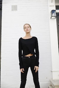 Young Woman Portrait Against White Brick Wall