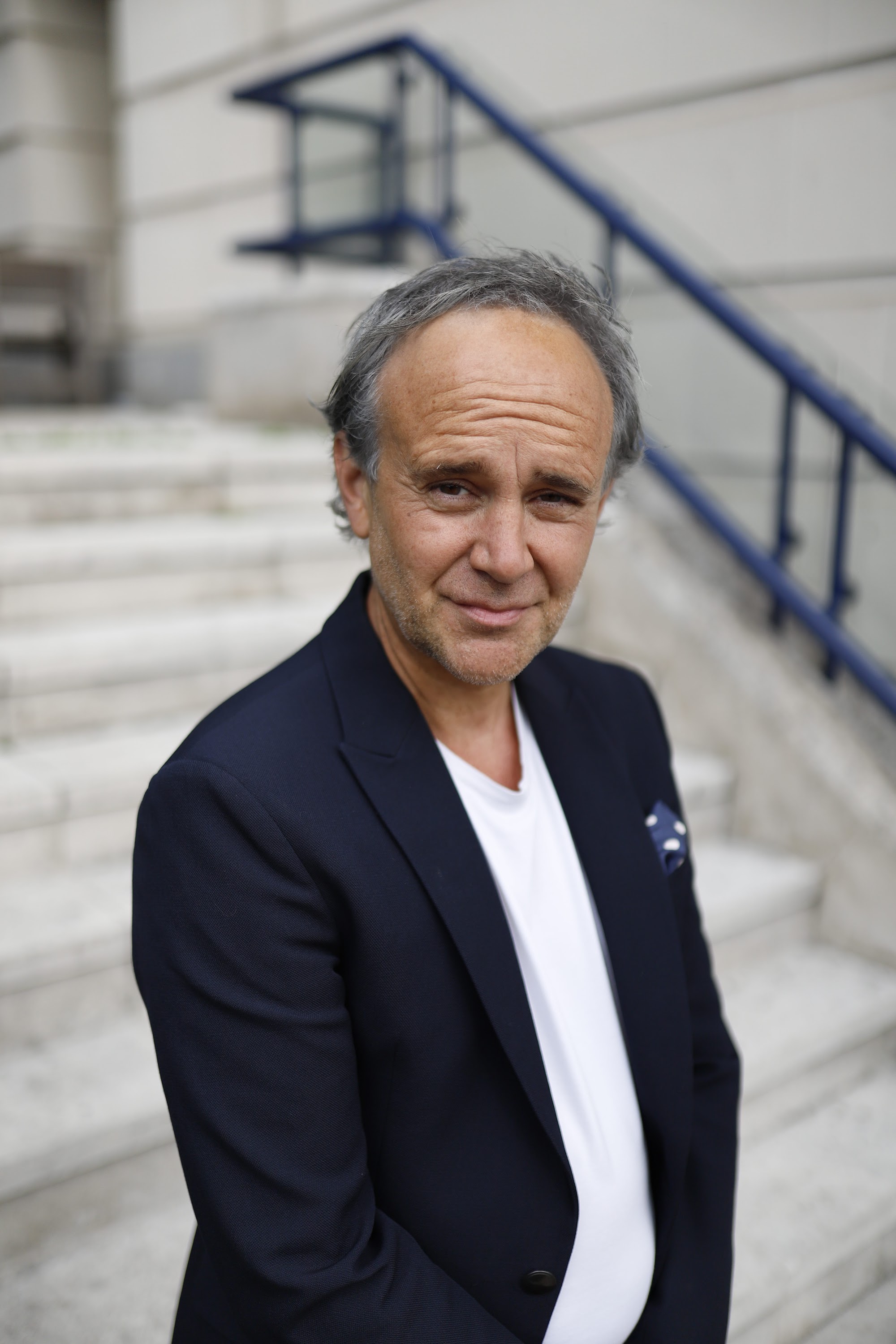 Man Leaning Against Stone Building — Urban Environmental Portrait