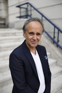 Man Leaning Against Stone Building — Urban Environmental Portrait