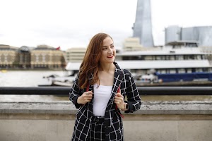 Smiling Young Woman on London Thames Riverfront
