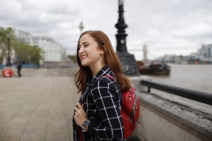 Smiling Young Woman on London Thames Riverfront