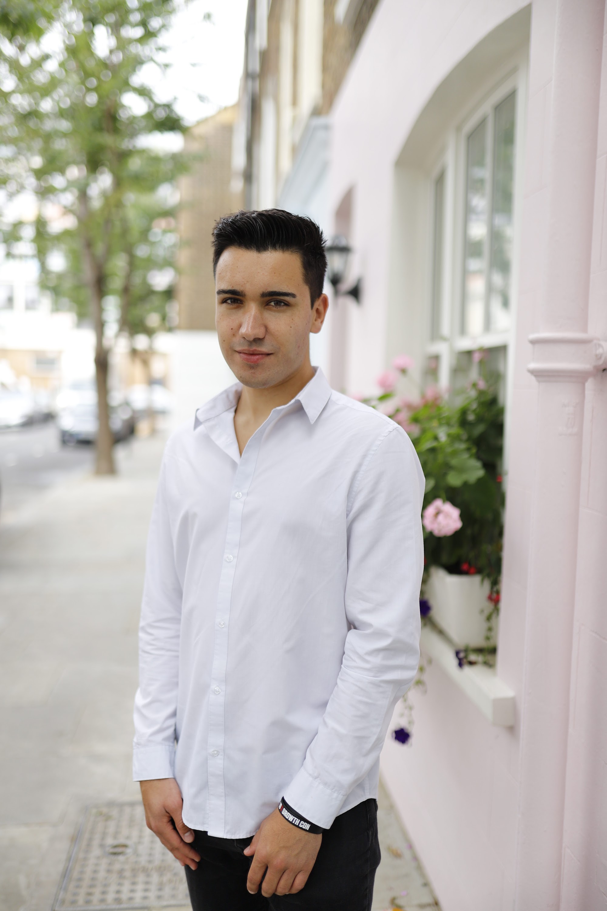 Young Man Leaning Against Brick Wall Outdoors