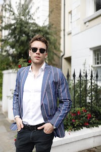 Man in Teal Overcoat on Colorful London Street