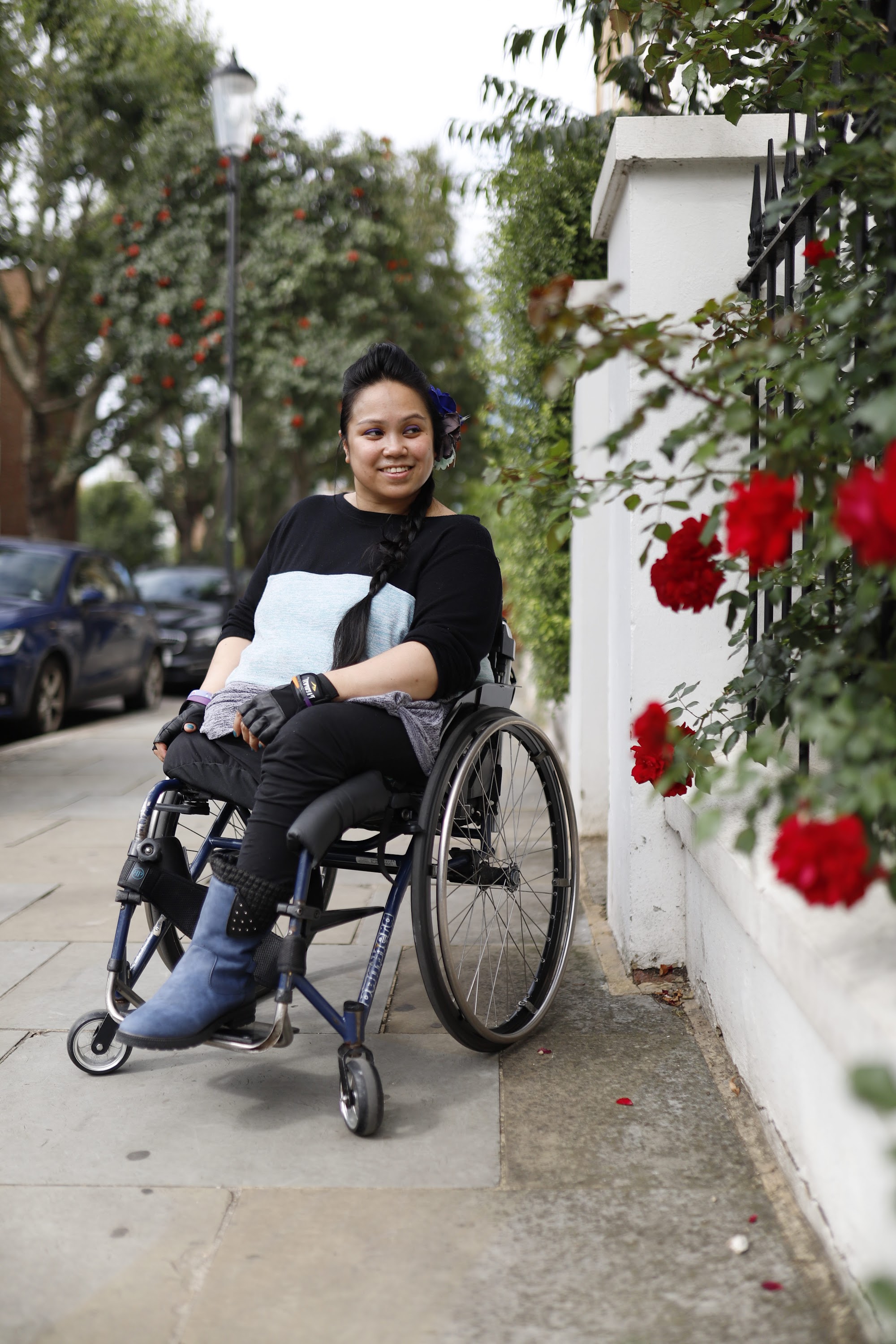 Young Woman in Wheelchair on Urban Sidewalk