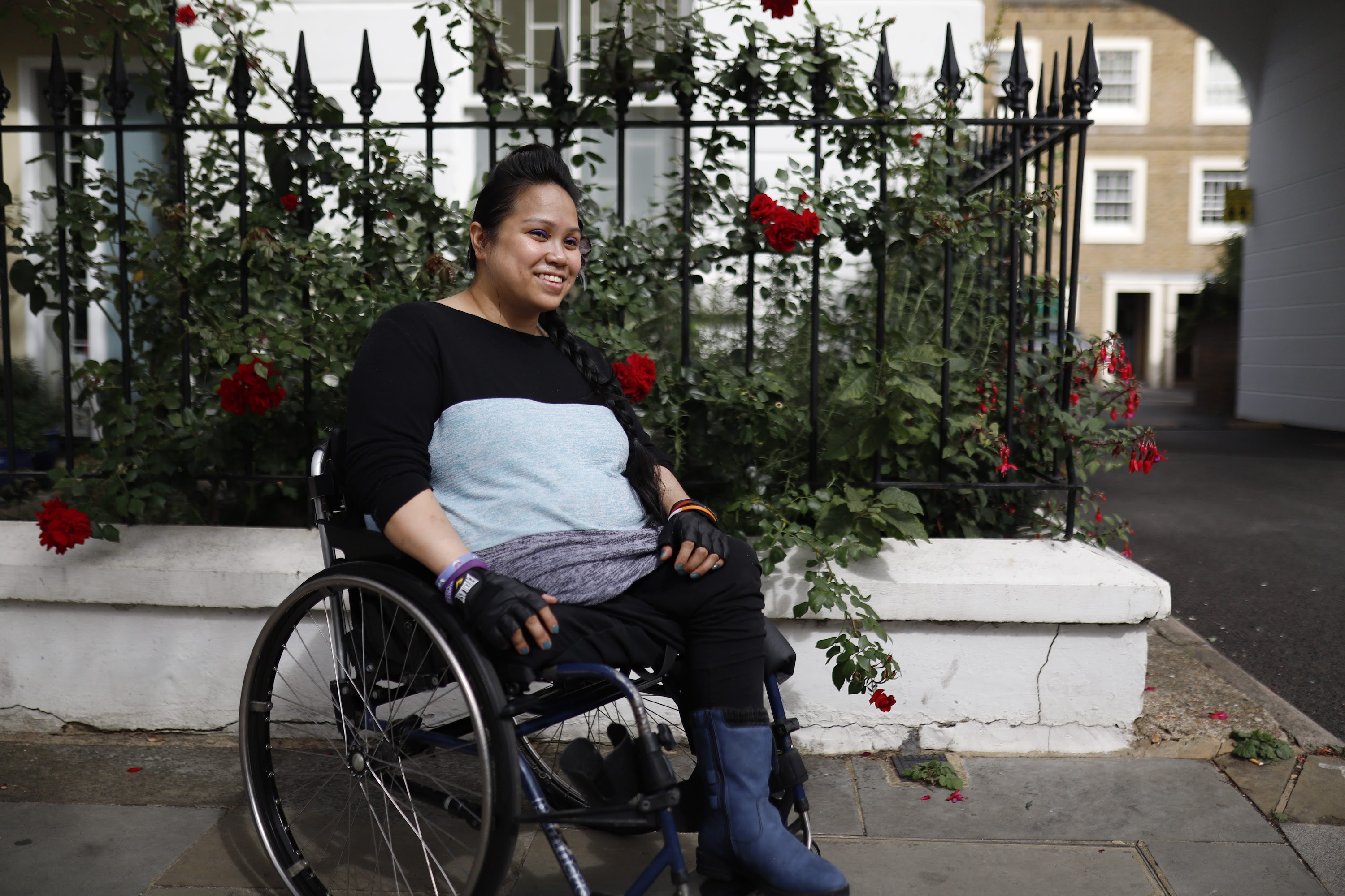 Young Woman in Wheelchair on Urban Sidewalk
