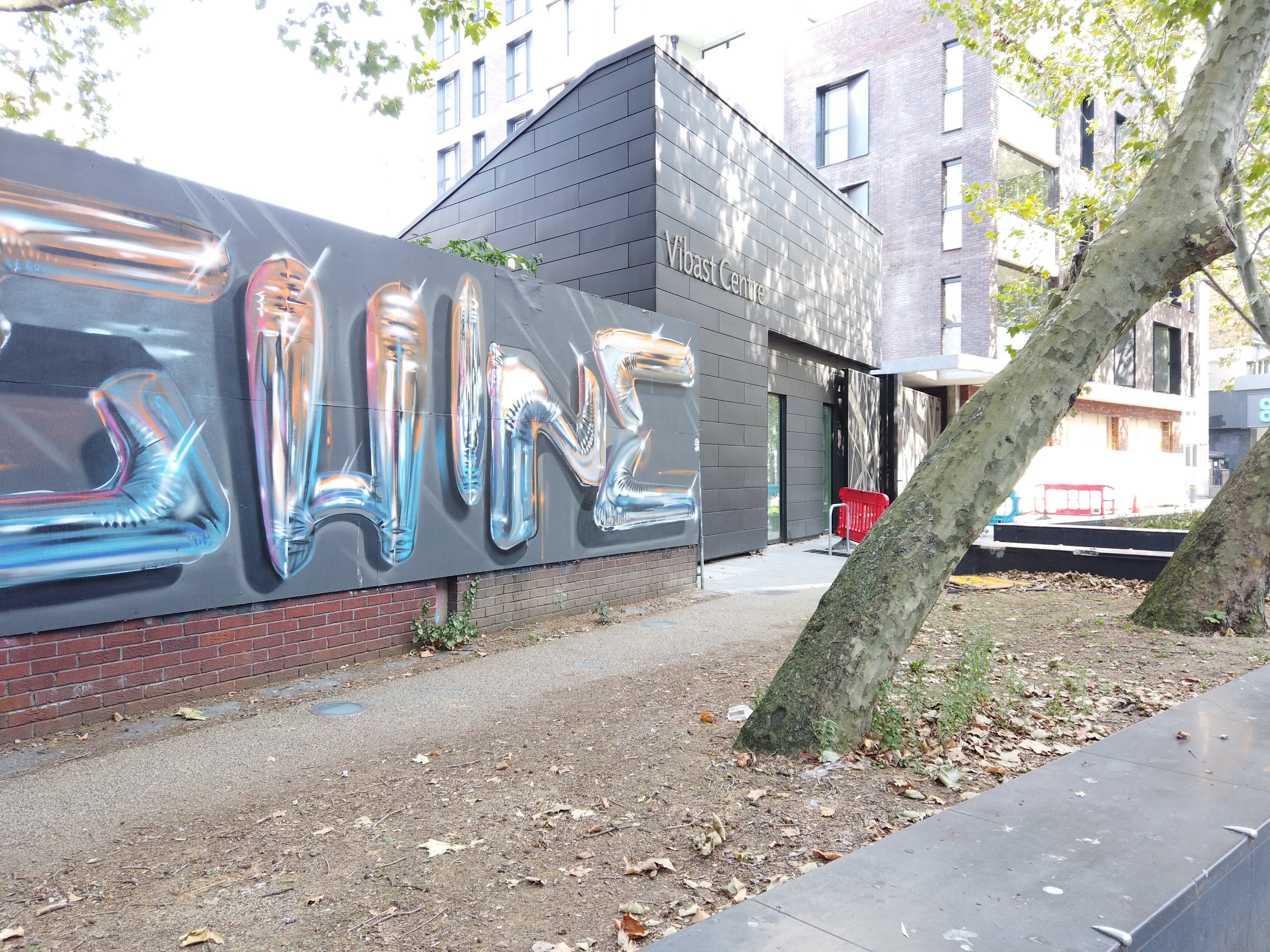 Street Mural with Balloon-Style Lettering on Urban Sidewalk