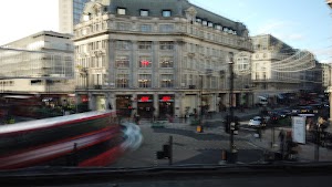 Motion-Blurred London Street with Red Double-Decker Buses