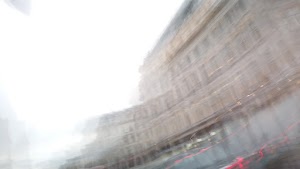 Motion-Blurred Urban Street Scene with Haussmann-Style Building