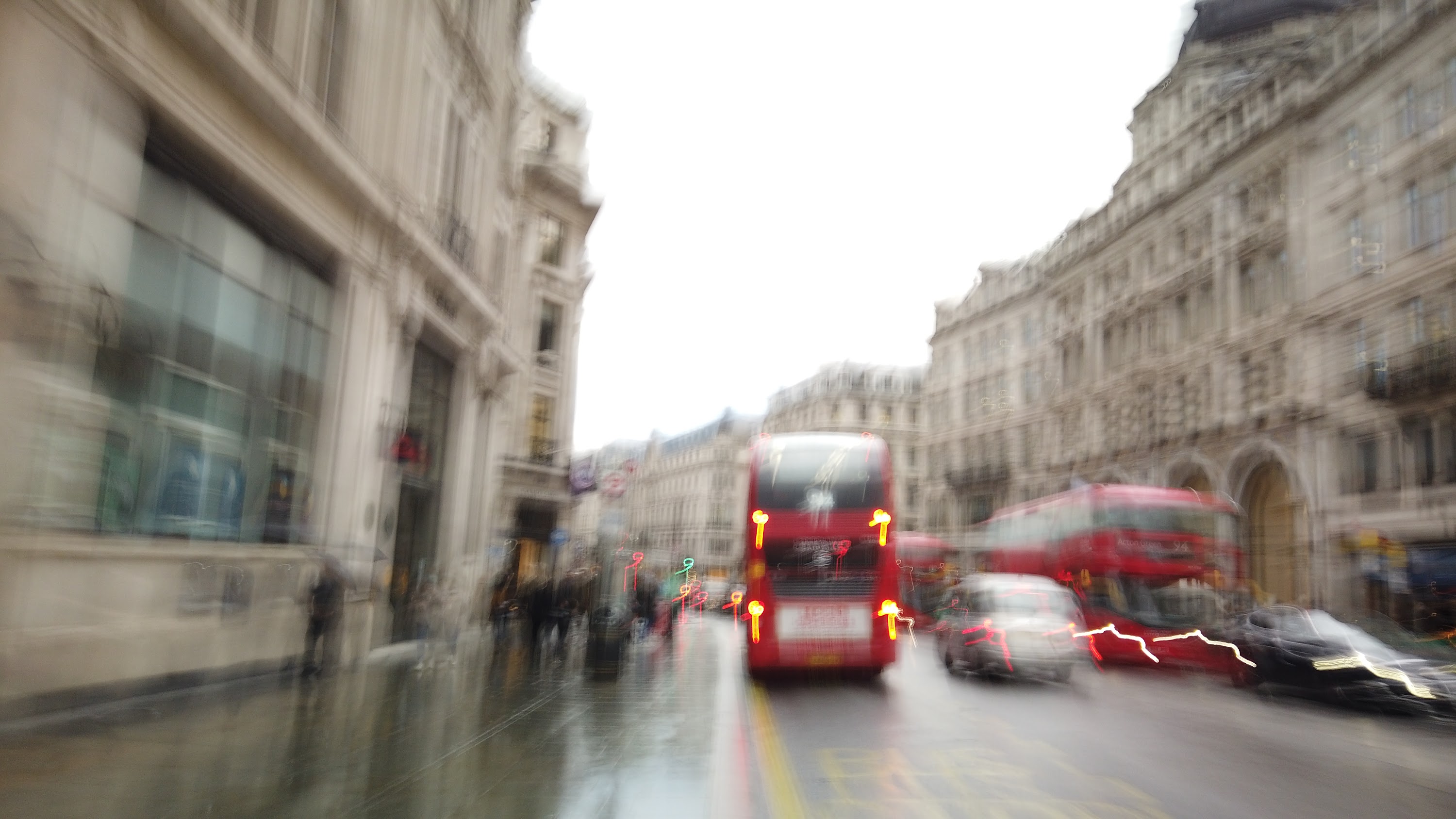 Blurred London Street Scene with Red Double-Decker Buses