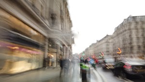 Blurred London Street Scene with Red Double-Decker Buses