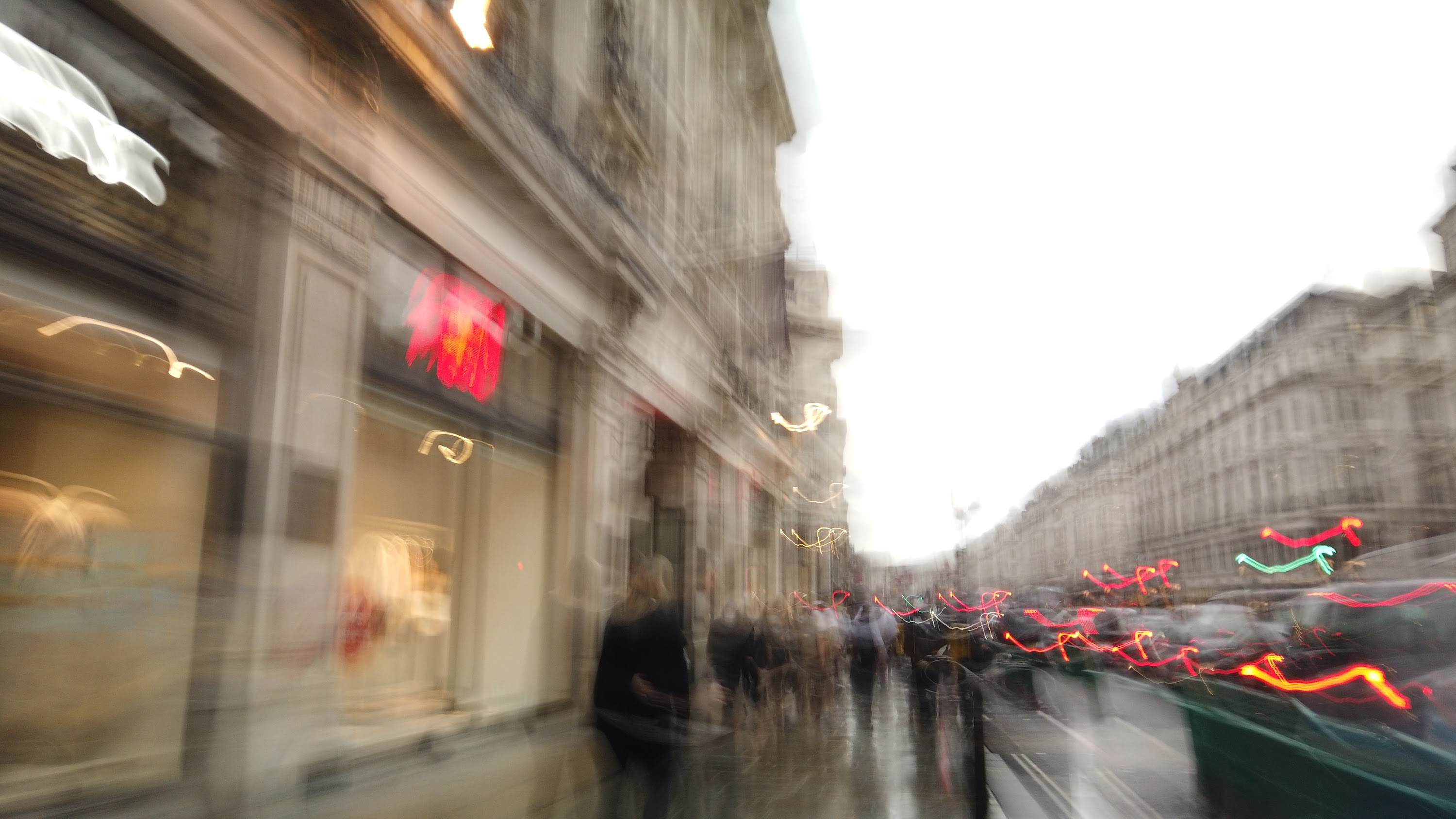 Blurred London Street Scene with Red Double-Decker Buses