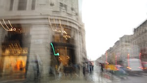 Blurred London Street Scene with Red Double-Decker Buses