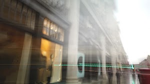 Blurred London Street Scene with Red Double-Decker Buses