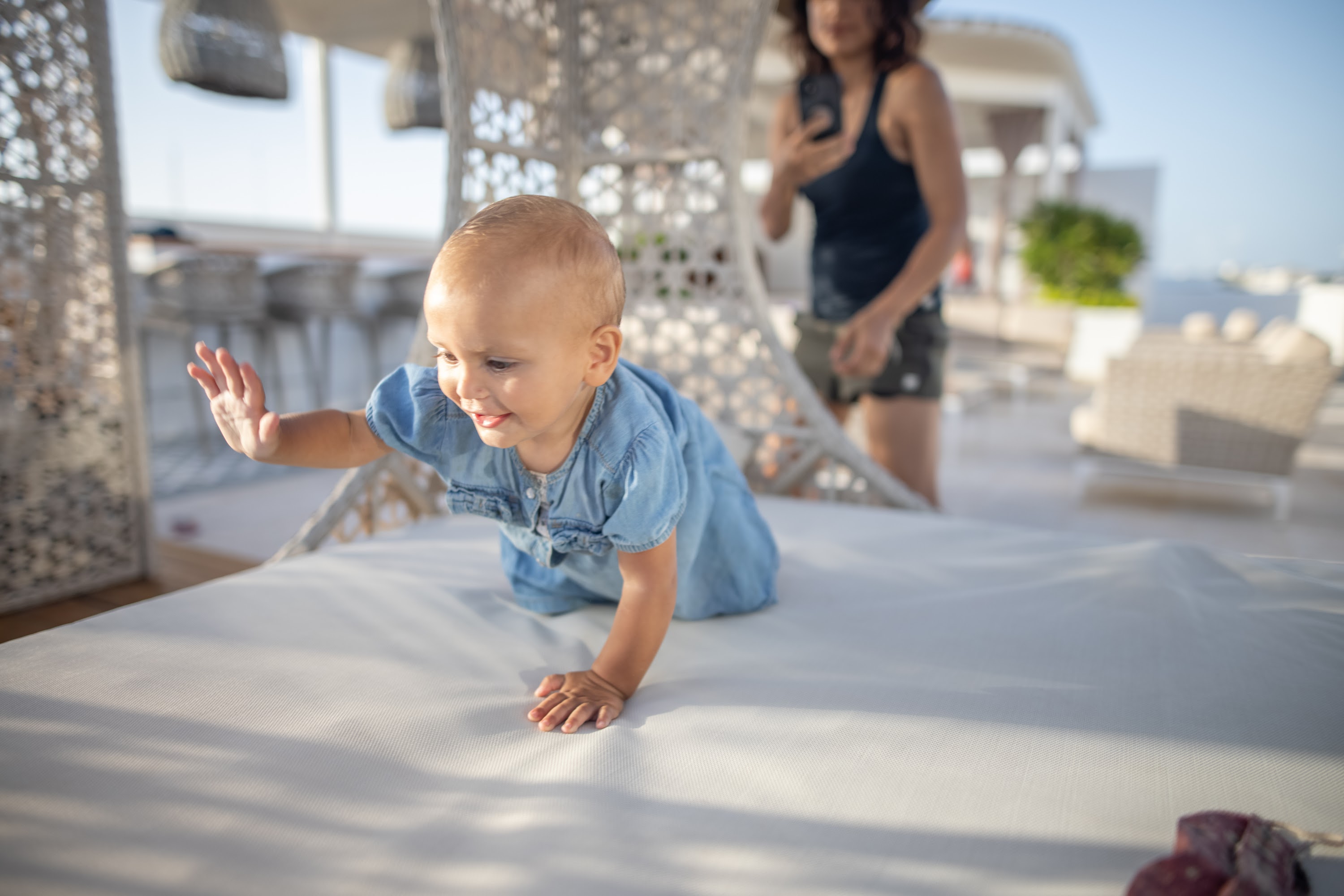 Baby Crawling on Outdoor Lounge Bed