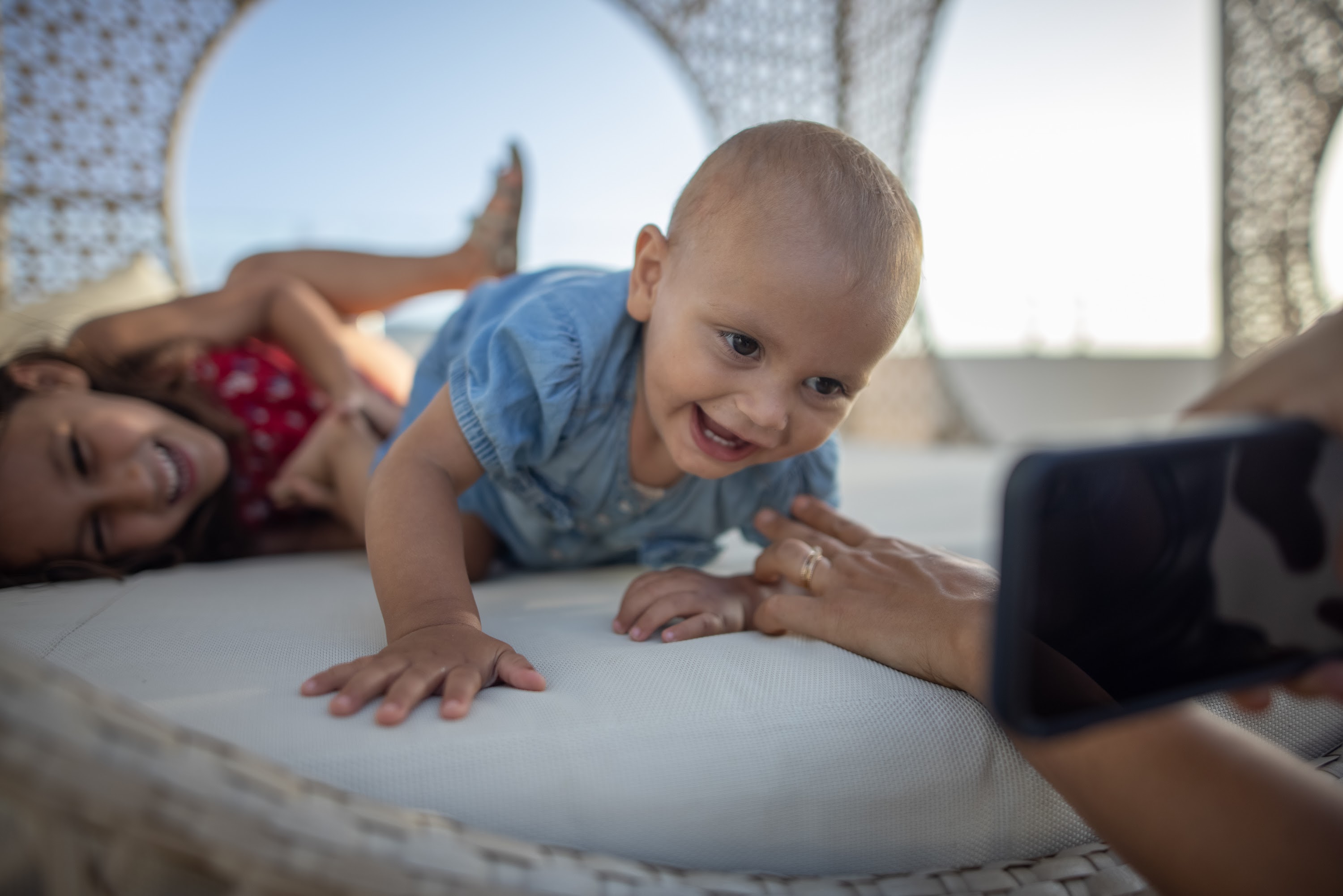 Baby and Sister Smiling During Outdoor Photo Session