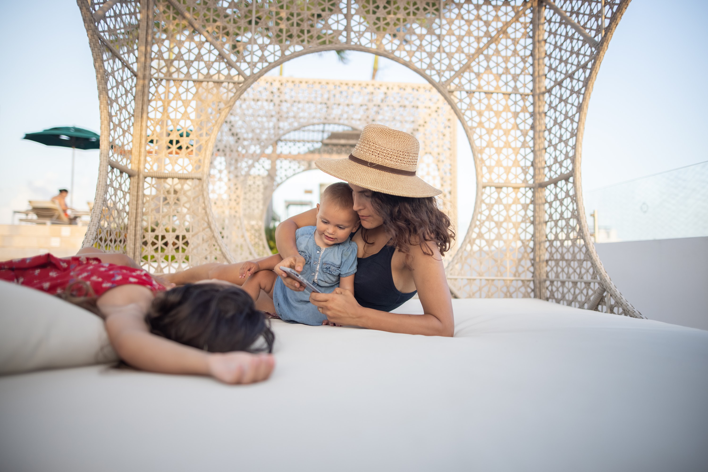 Mother and Child Relaxing on Rooftop Lounger
