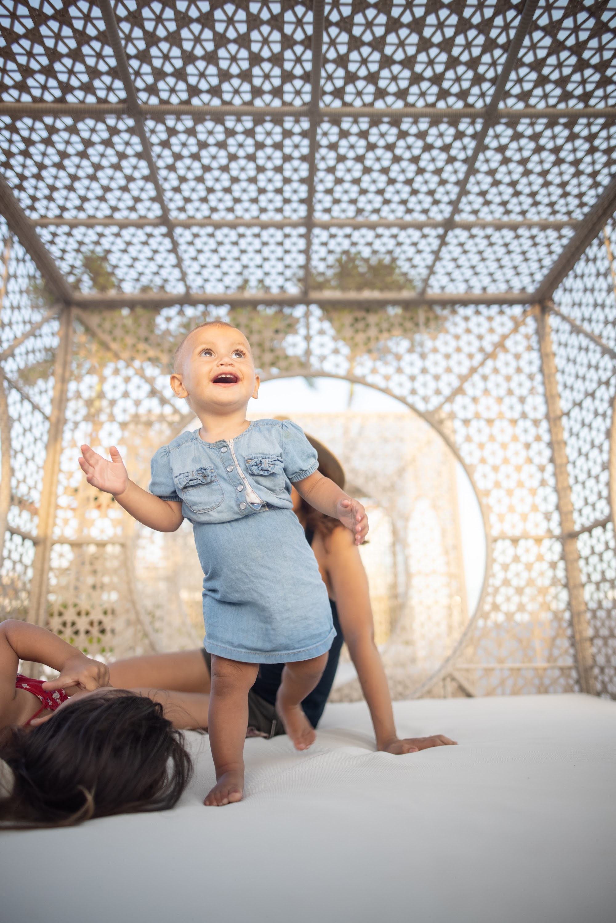 Happy Baby Standing Under Perforated Canopy