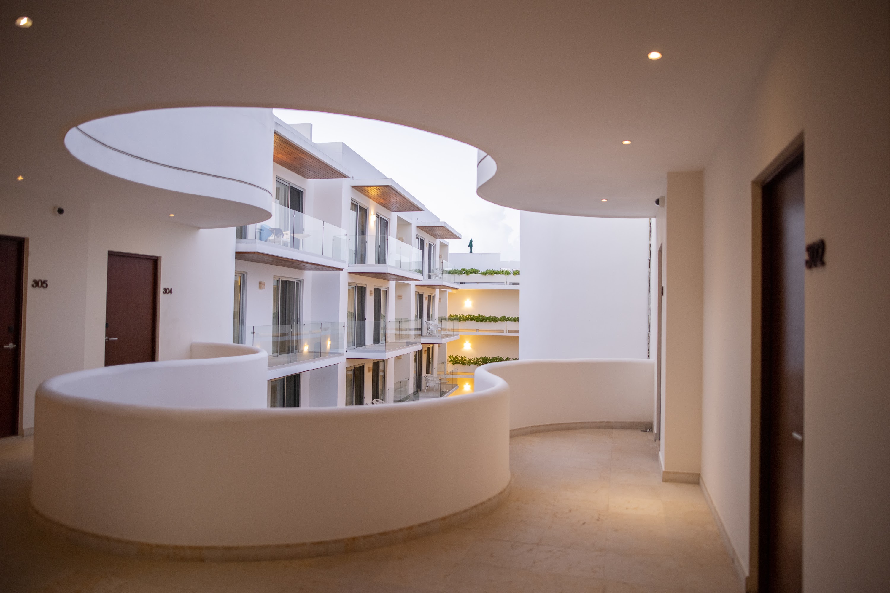 Modern Hotel Corridor with Curved Architecture and Balconies