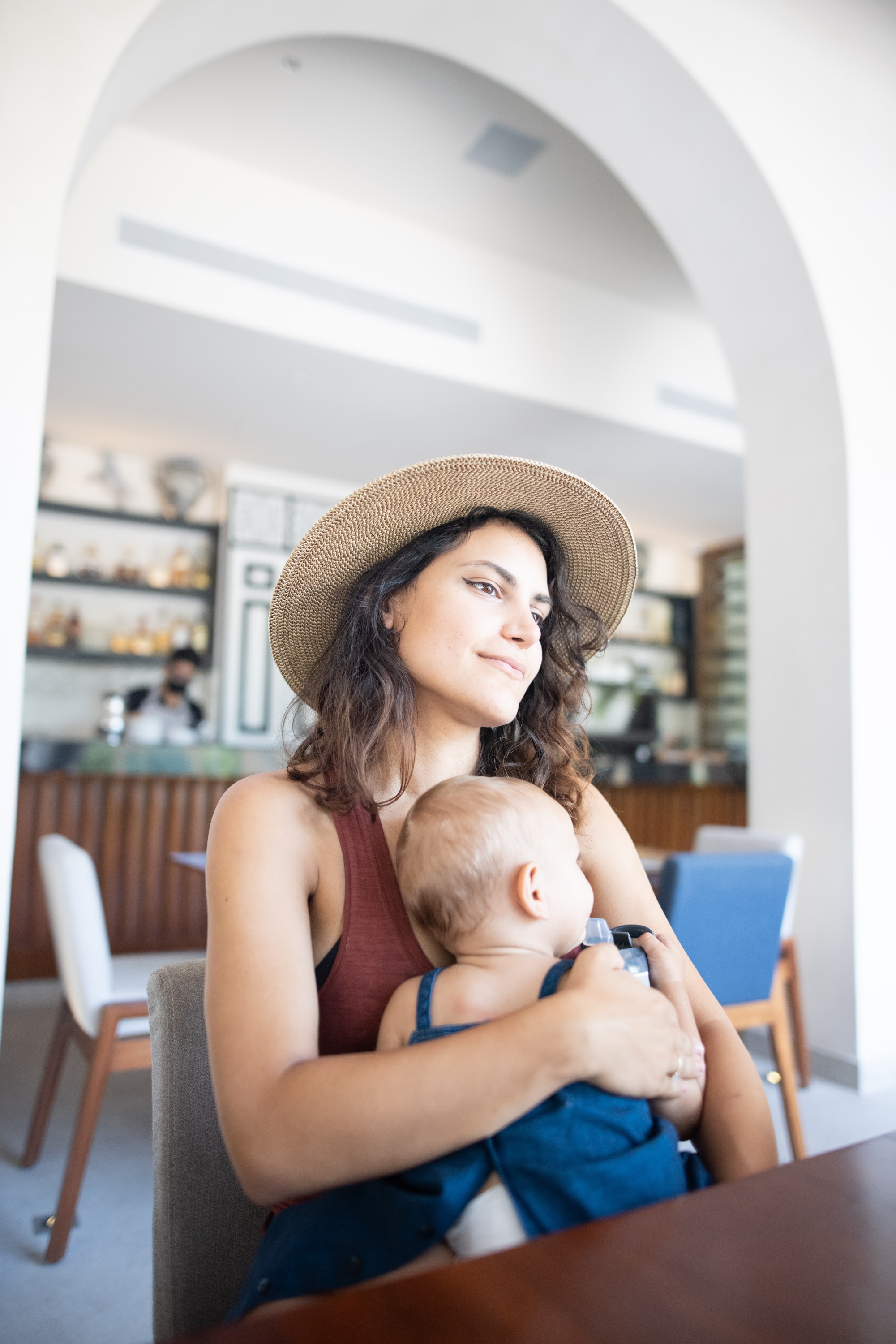 Mother holding baby in a café