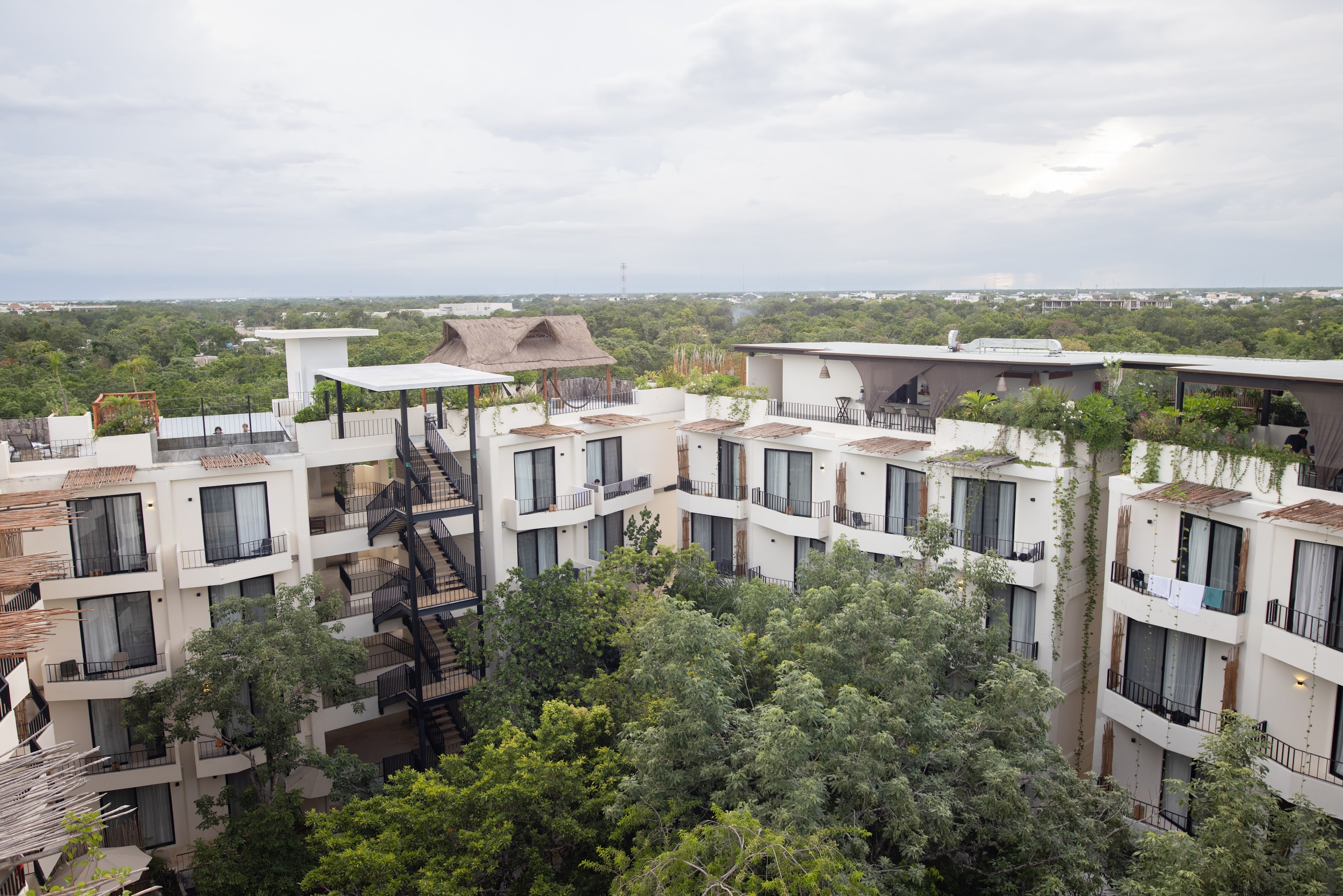 Modern White Apartment Complex with Rooftop Gardens and Spiral Staircase