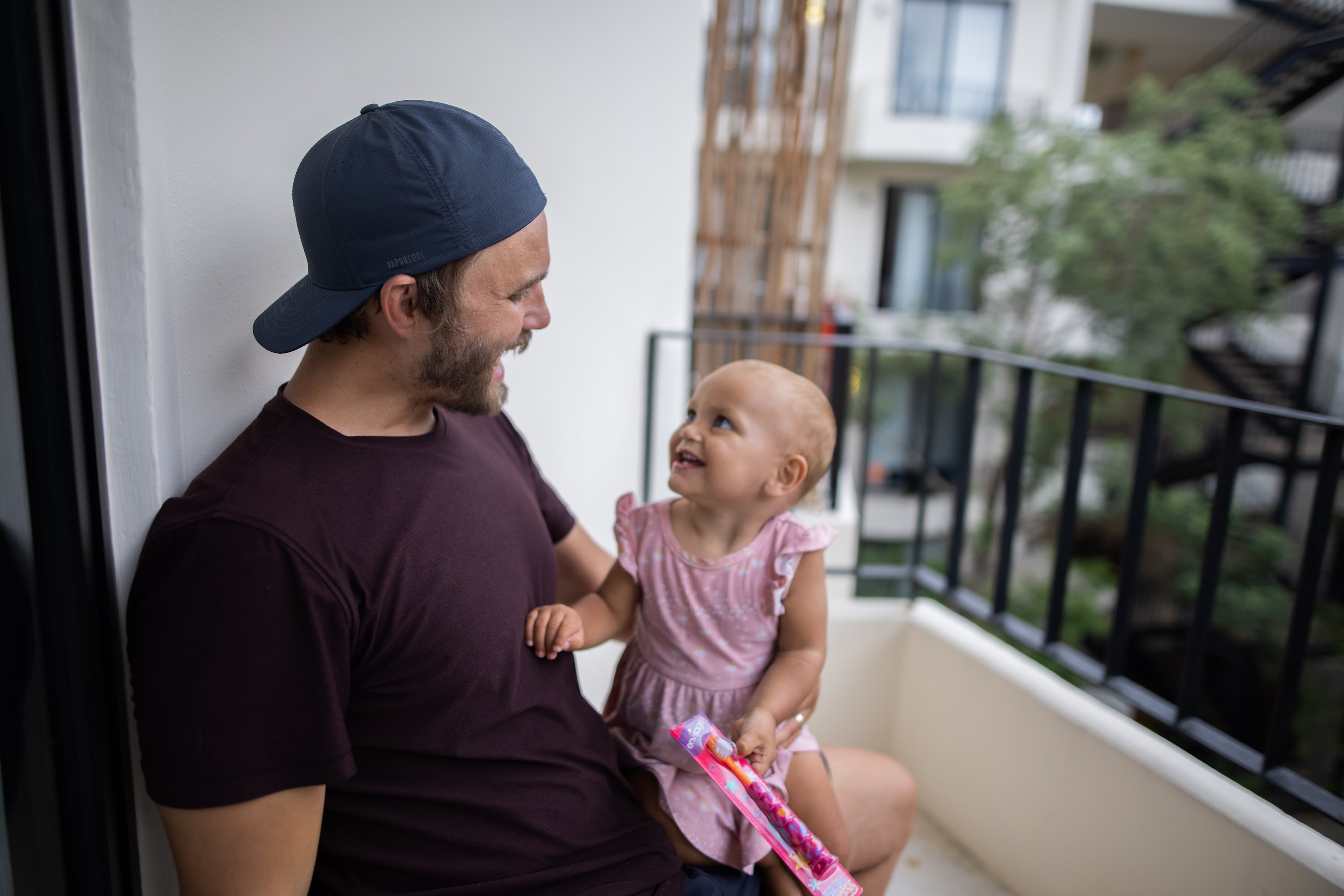 Father and Daughter Sharing a Joyful Moment on Balcony