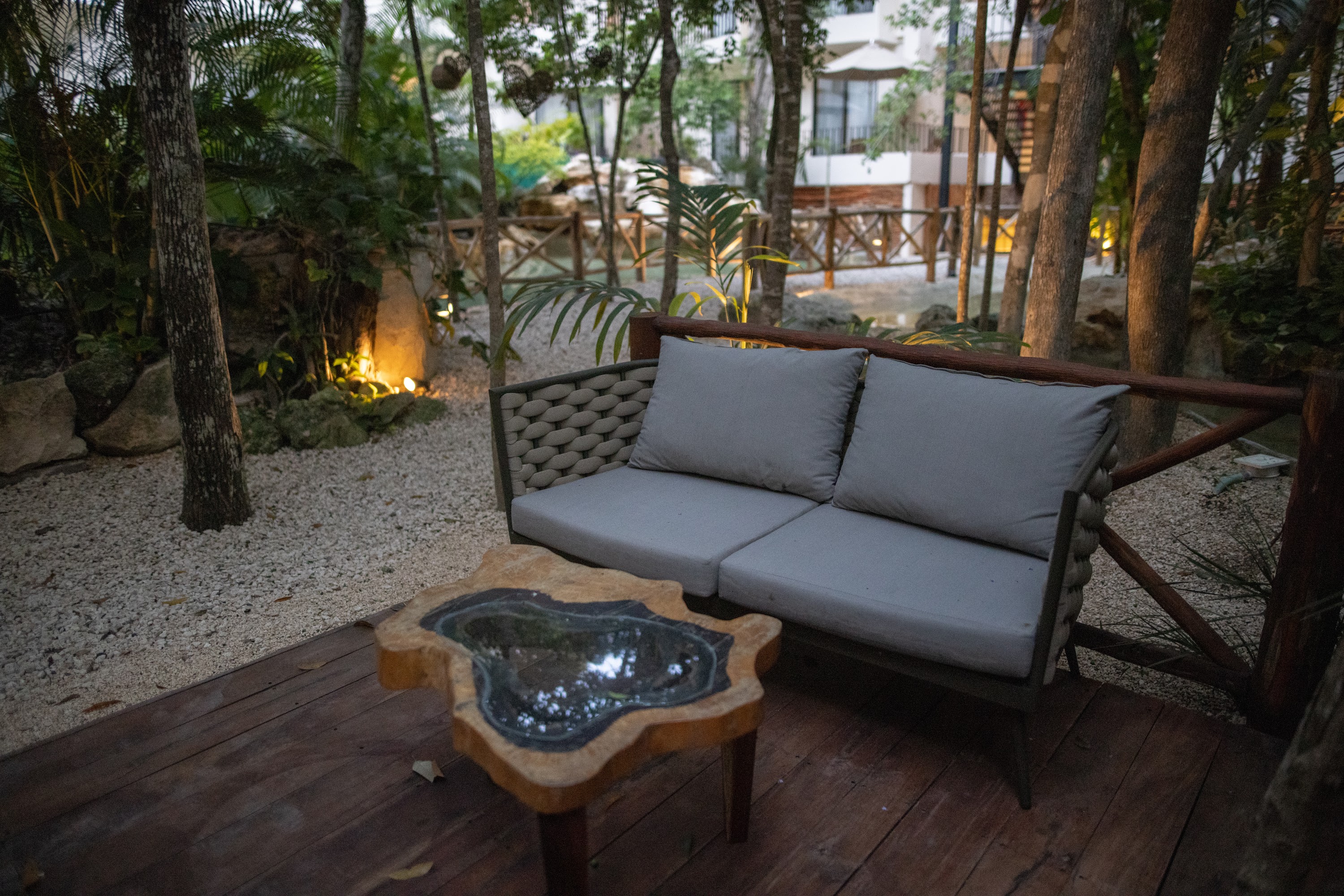 Wooden Deck with Modern Sofa and Natural Stone Coffee Table in Garden Setting