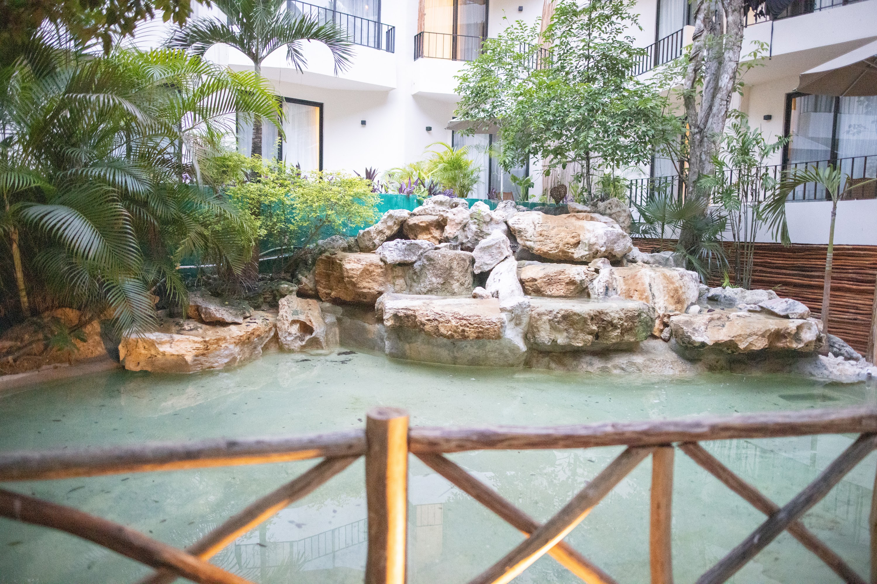 Hotel Atrium Courtyard with Rock Water Feature and Tropical Landscaping