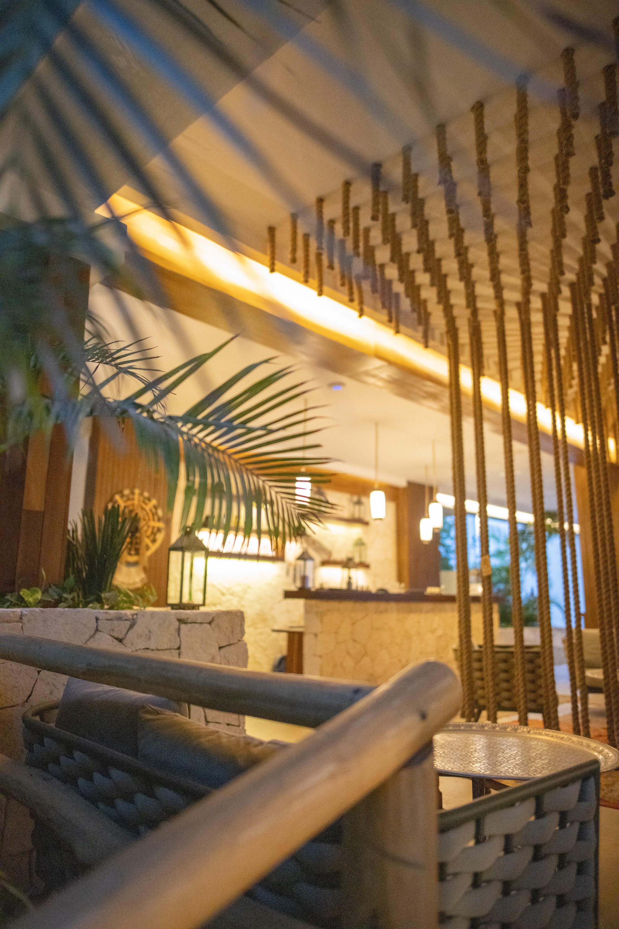 Tropical Lounge with Rope Chandelier and Palm Fronds