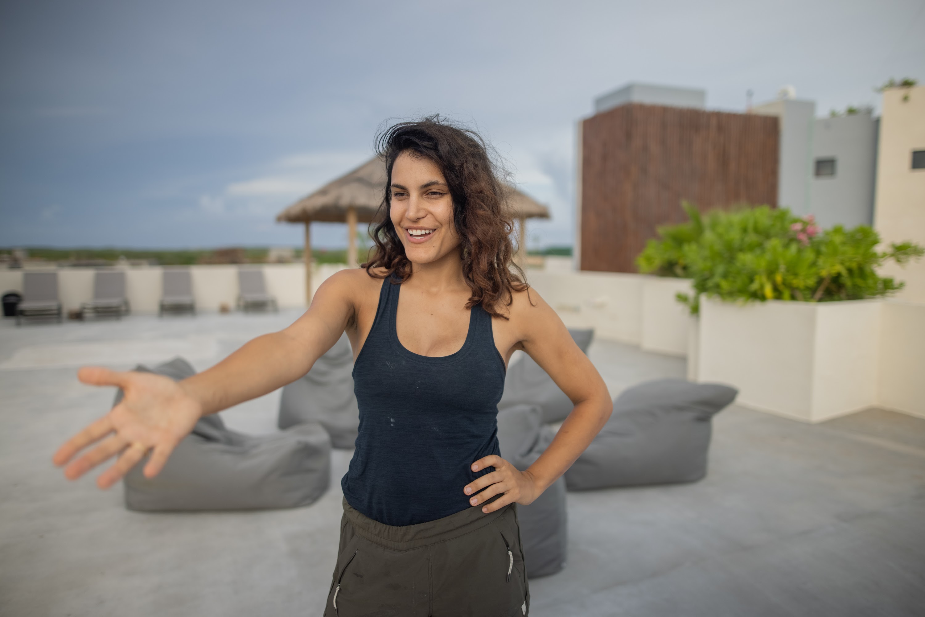 Smiling Woman Welcoming on Rooftop Terrace