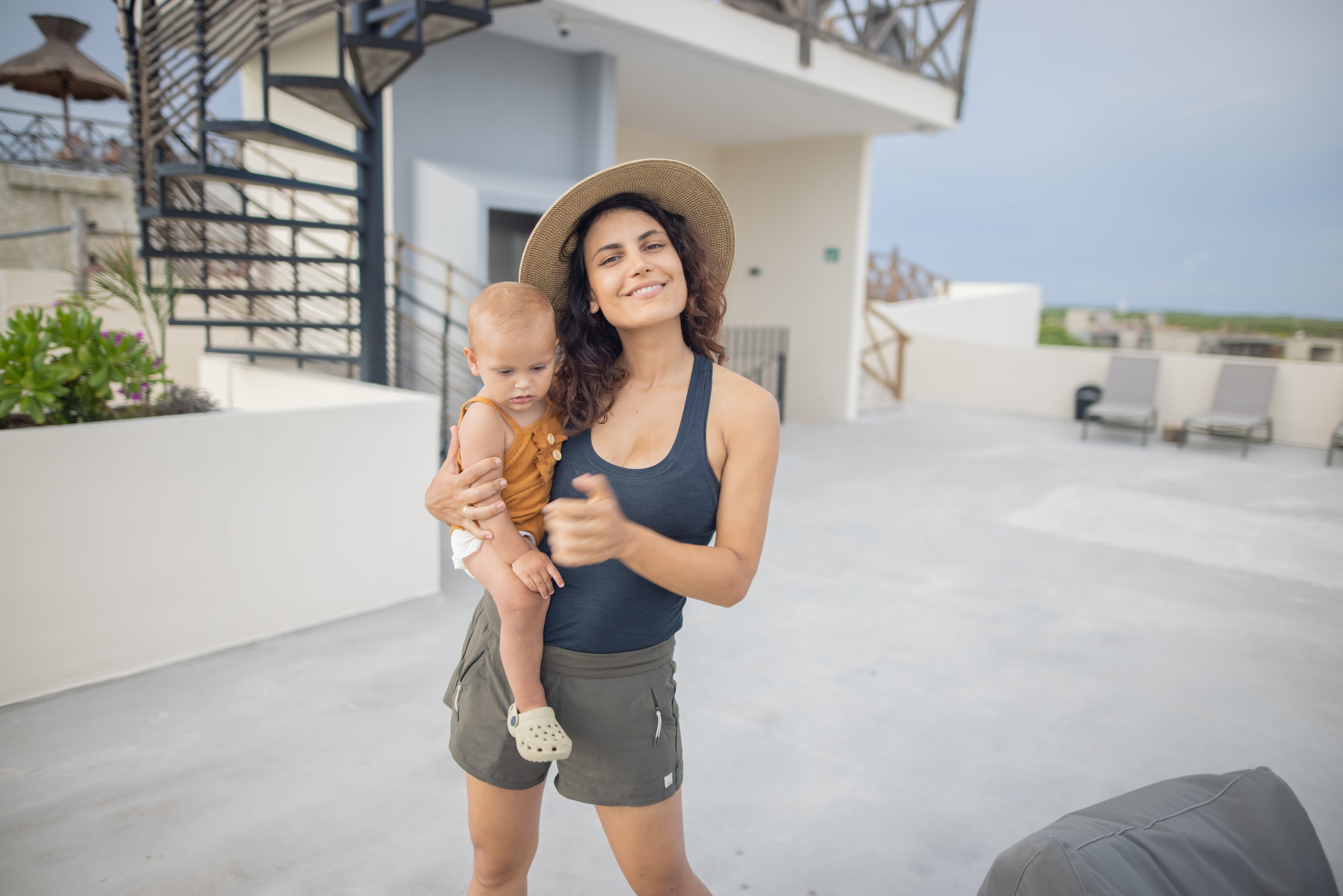 Mother Holding Baby on Rooftop Terrace
