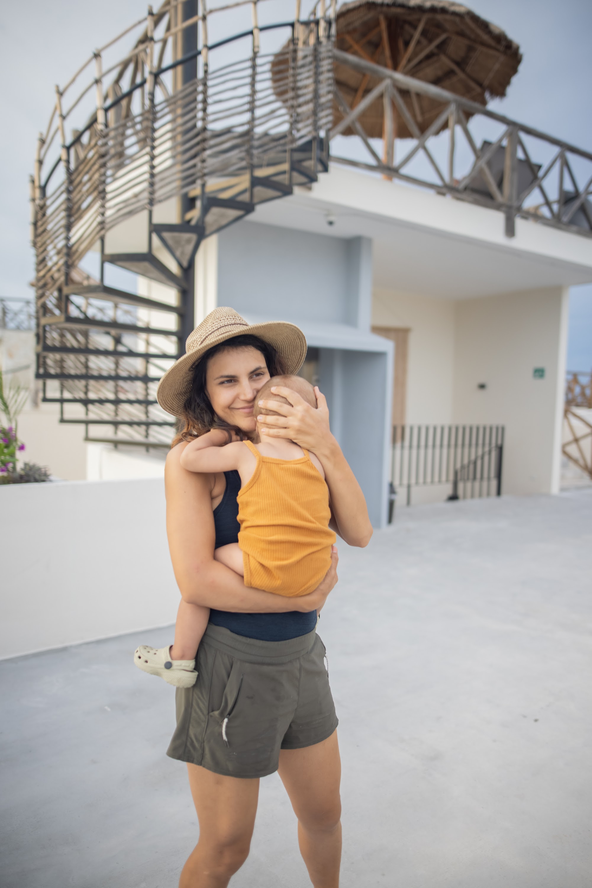 Mother Holding Baby on Resort Terrace